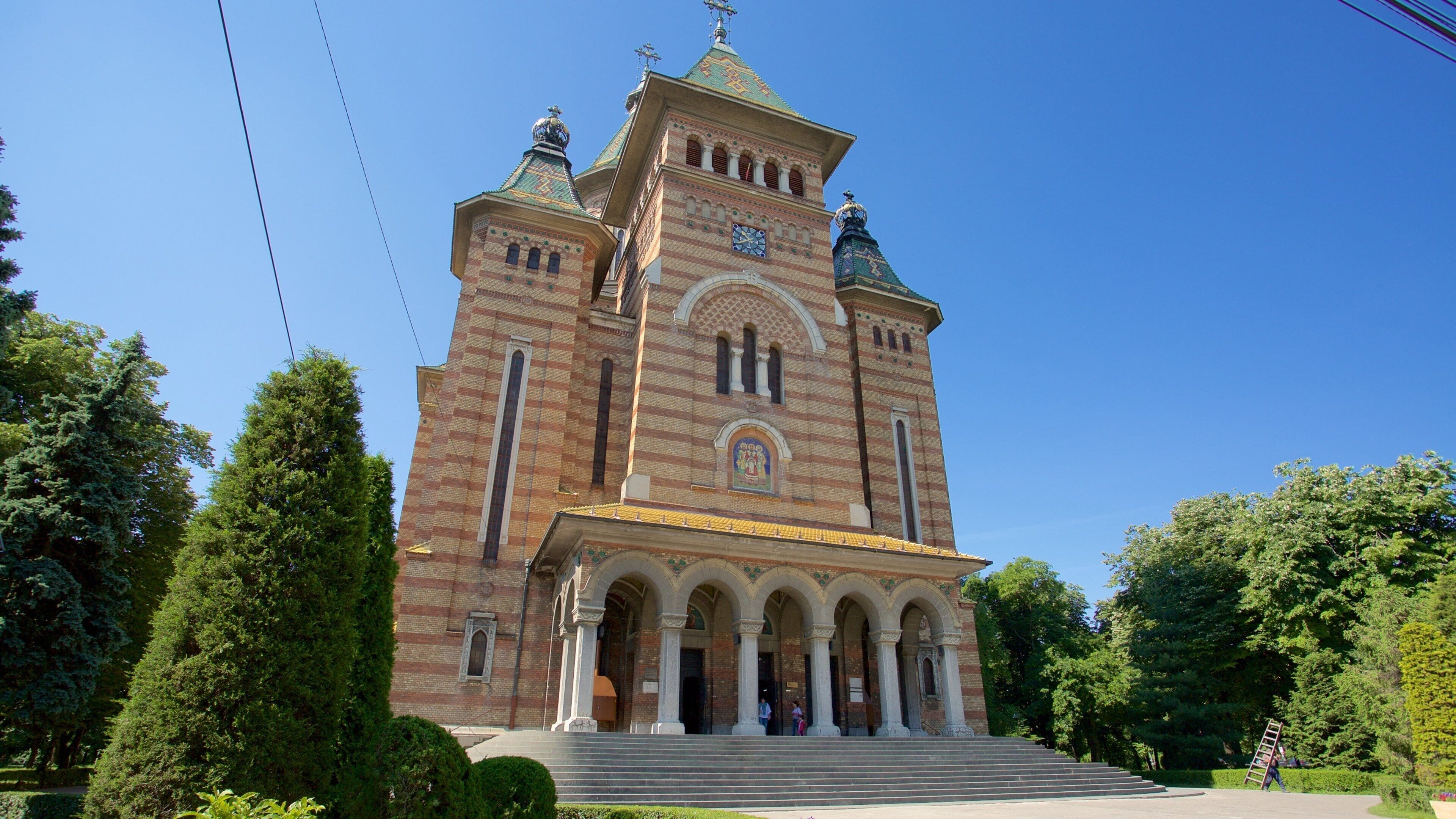 A large brick church with a clock tower and a dome.