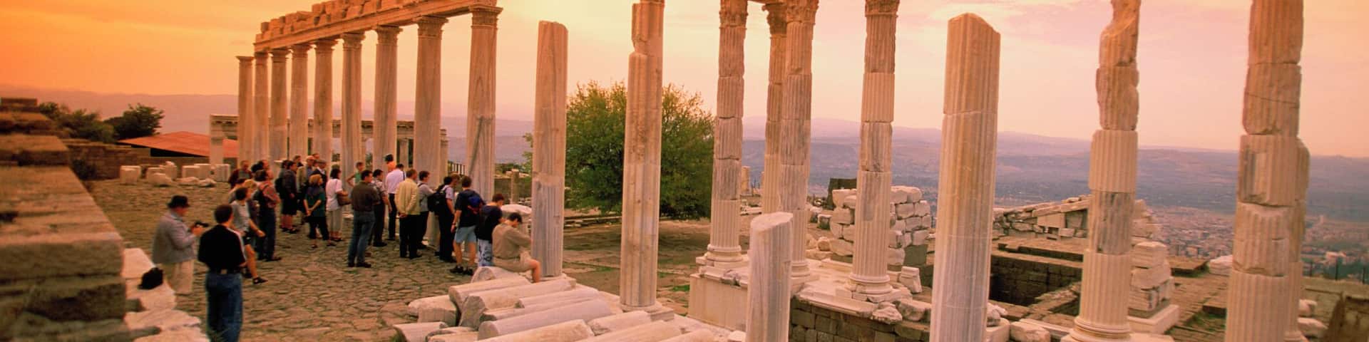 Tourists at the ruins of the Temple of Trajan at sunset in Pergamon, Bergama, Aegean region, Turkey