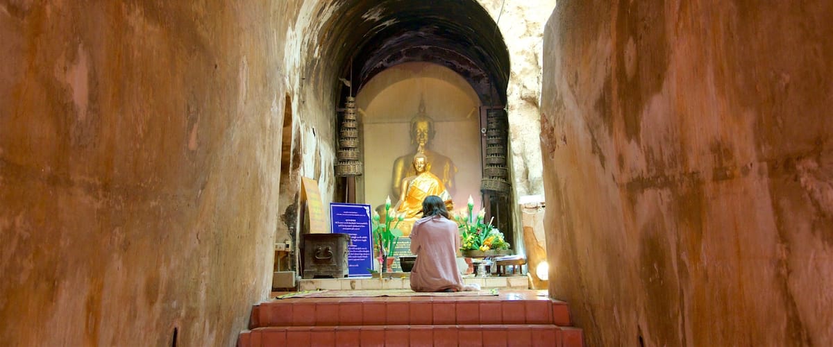 Wat Umong featuring a temple or place of worship as well as an individual femail