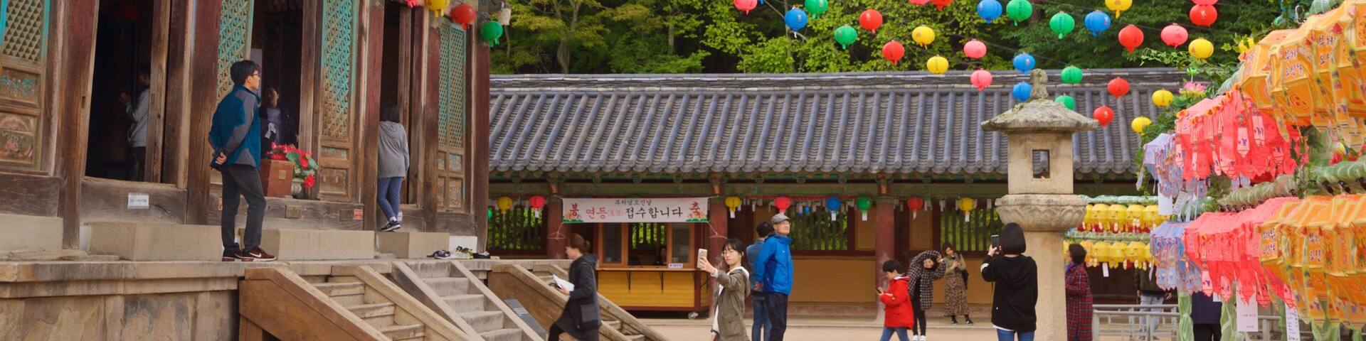 Bulguksa Temple featuring a temple or place of worship and heritage elements as well as a small group of people