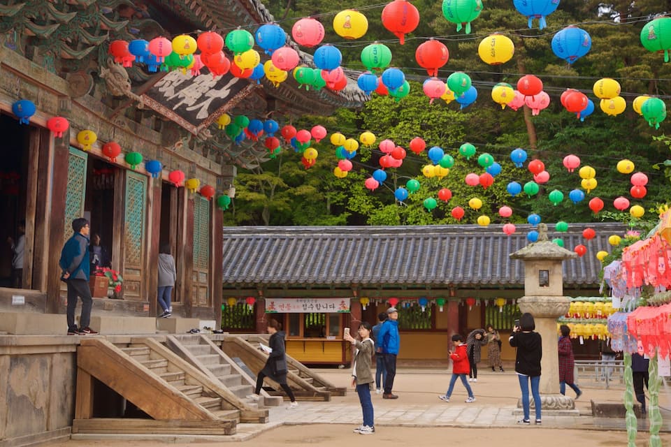 A traditional building with colorful lanterns hanging above.