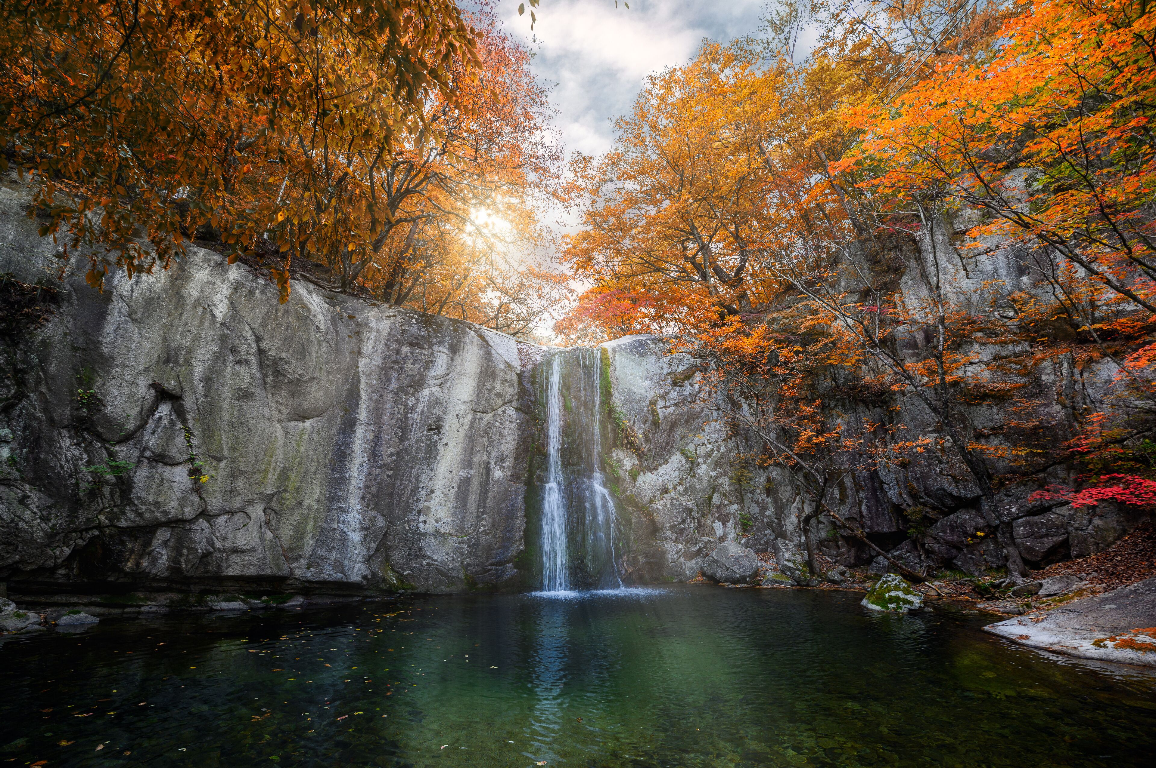 Waterfall flowing in autumn forest on national park