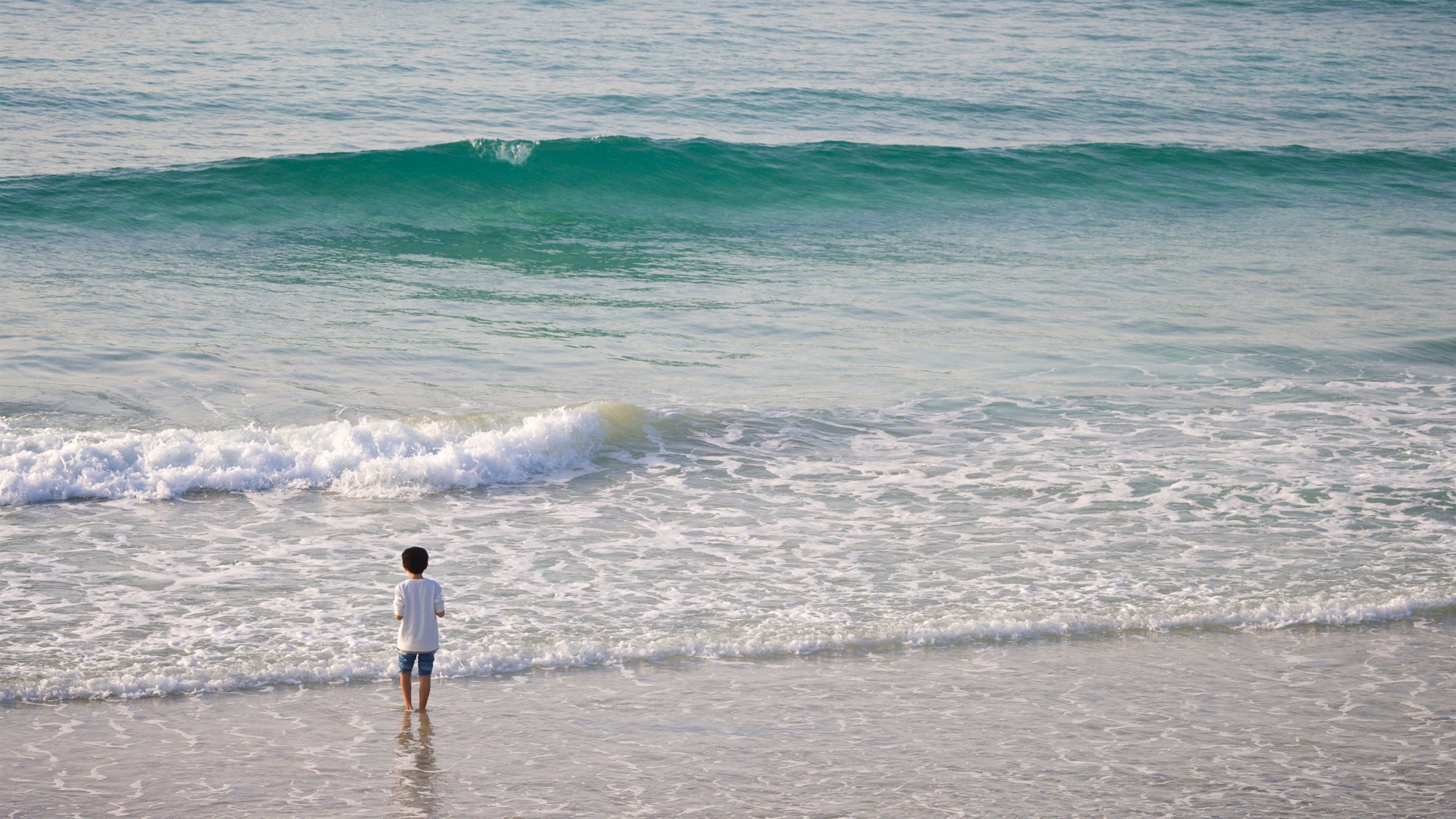 St Maarten and St Martin which includes surf and general coastal views as well as an individual child