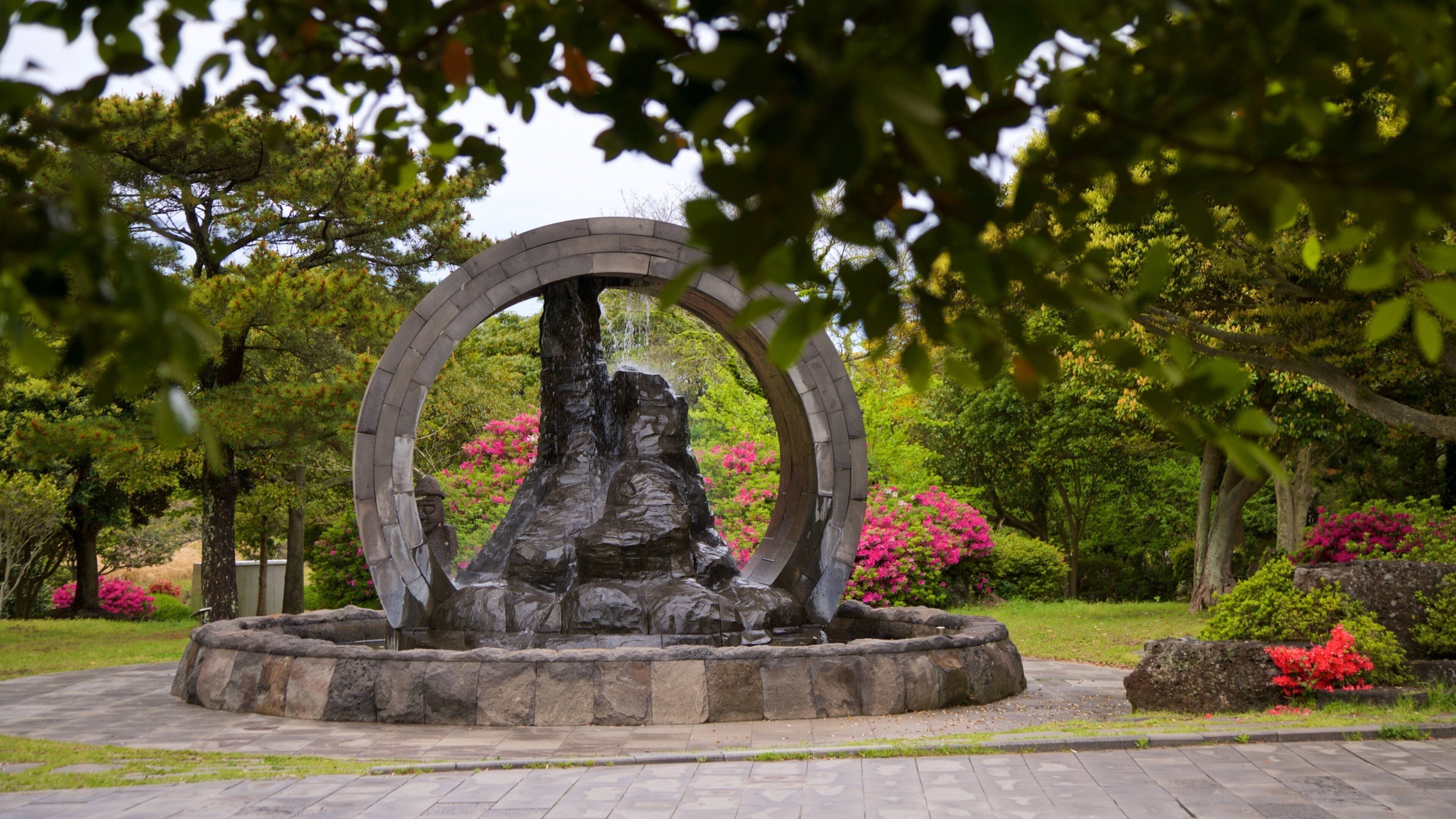 Manjanggul Lava-tube Cave which includes wildflowers, a garden and a fountain