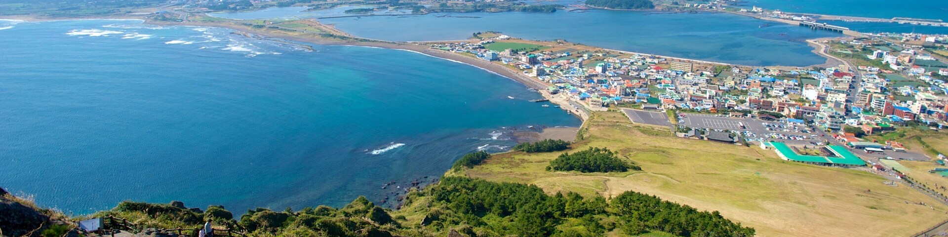Seongsan Ilchulbong which includes landscape views, general coastal views and a coastal town