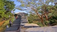 Hwaseong Fortress featuring heritage elements and a garden as well as a small group of people