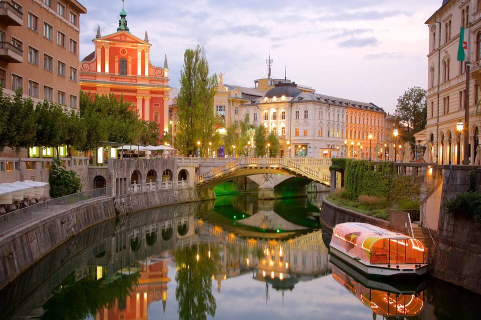 A canal with a boat, a bridge, and historic buildings.