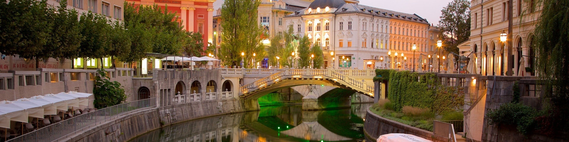 A canal with a boat, a bridge, and historic buildings.