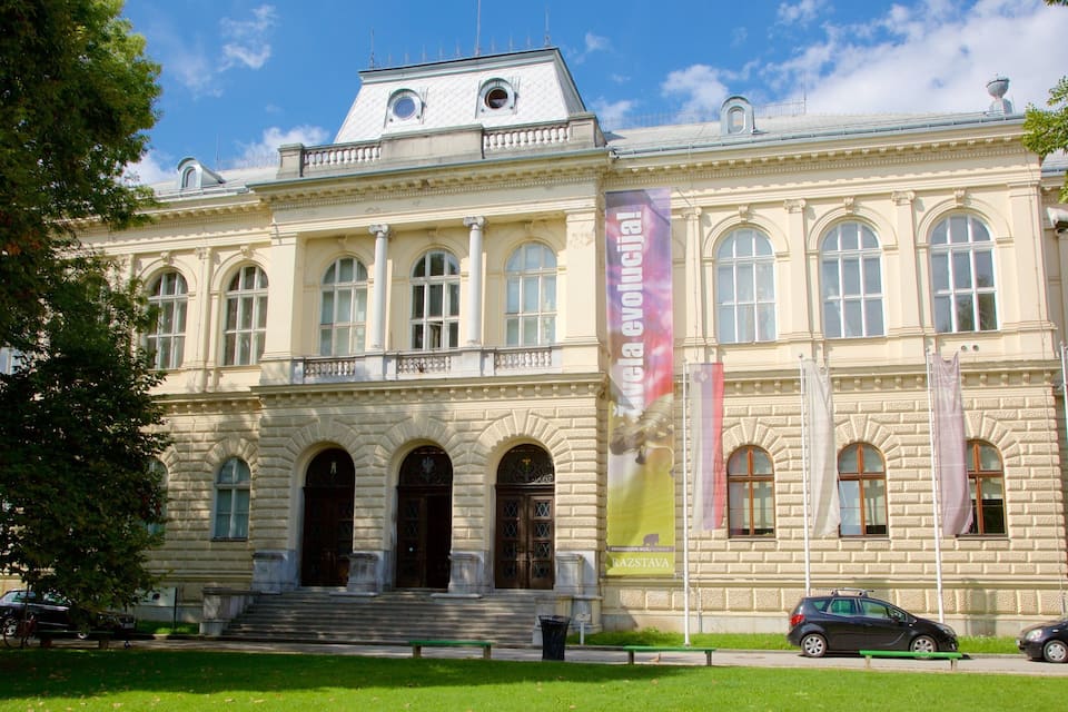 A historic building with arched windows and a prominent entrance.