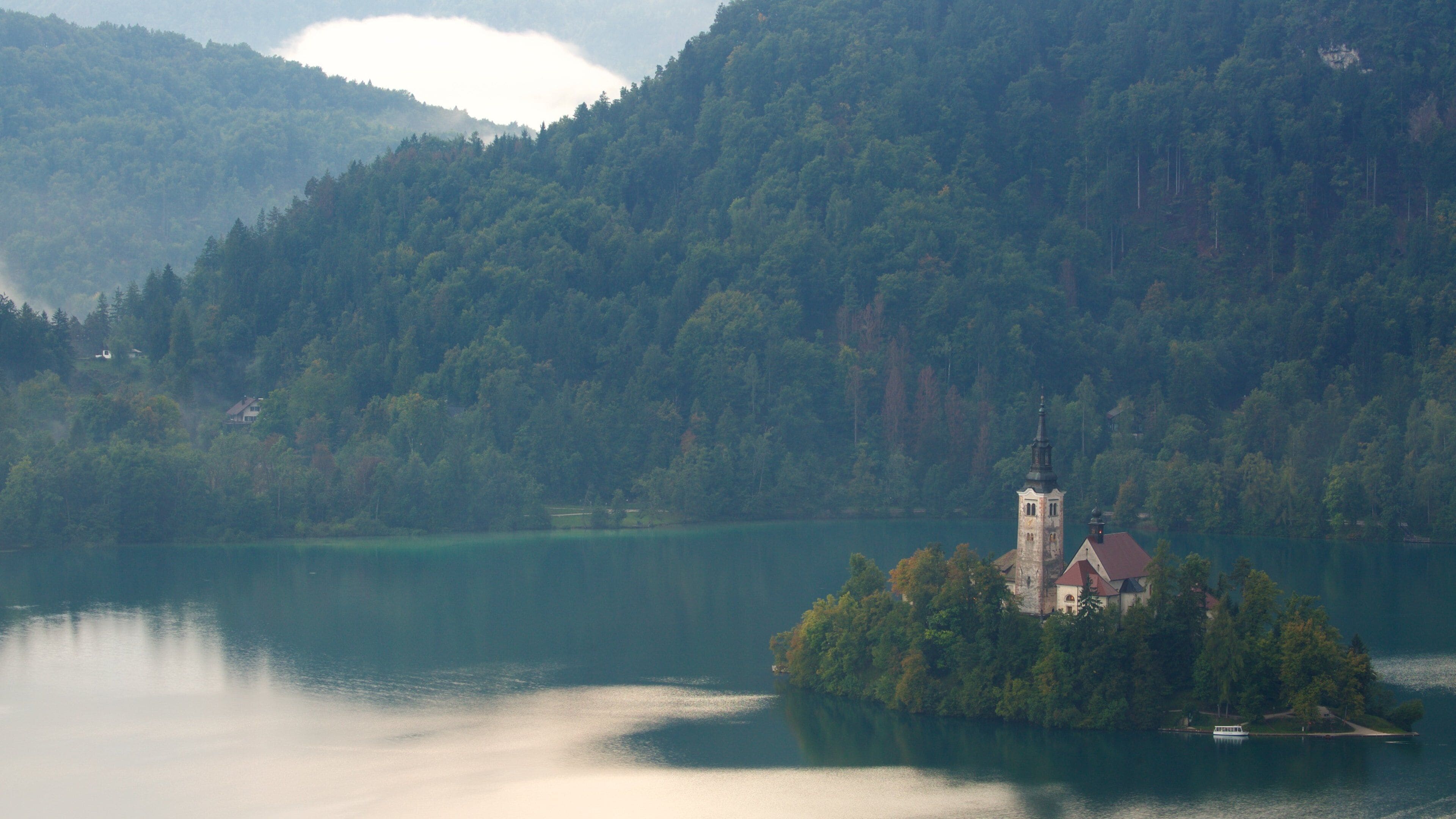 Iglesia de Sv Marika Bozja que incluye una iglesia o catedral, un lago o abrevadero y escenas forestales