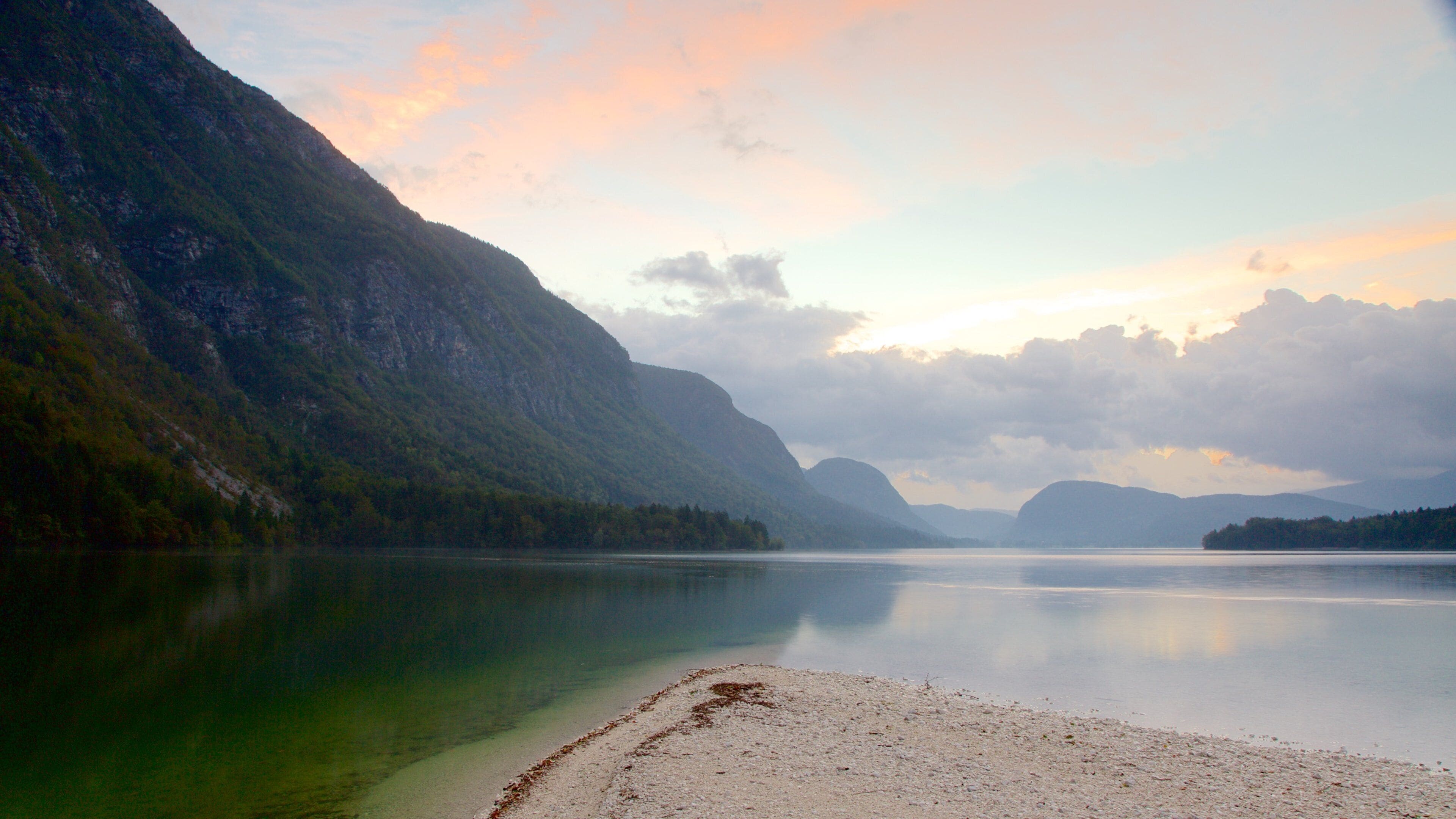 Lake Bohinj showing a sunset, mountains and a lake or waterhole