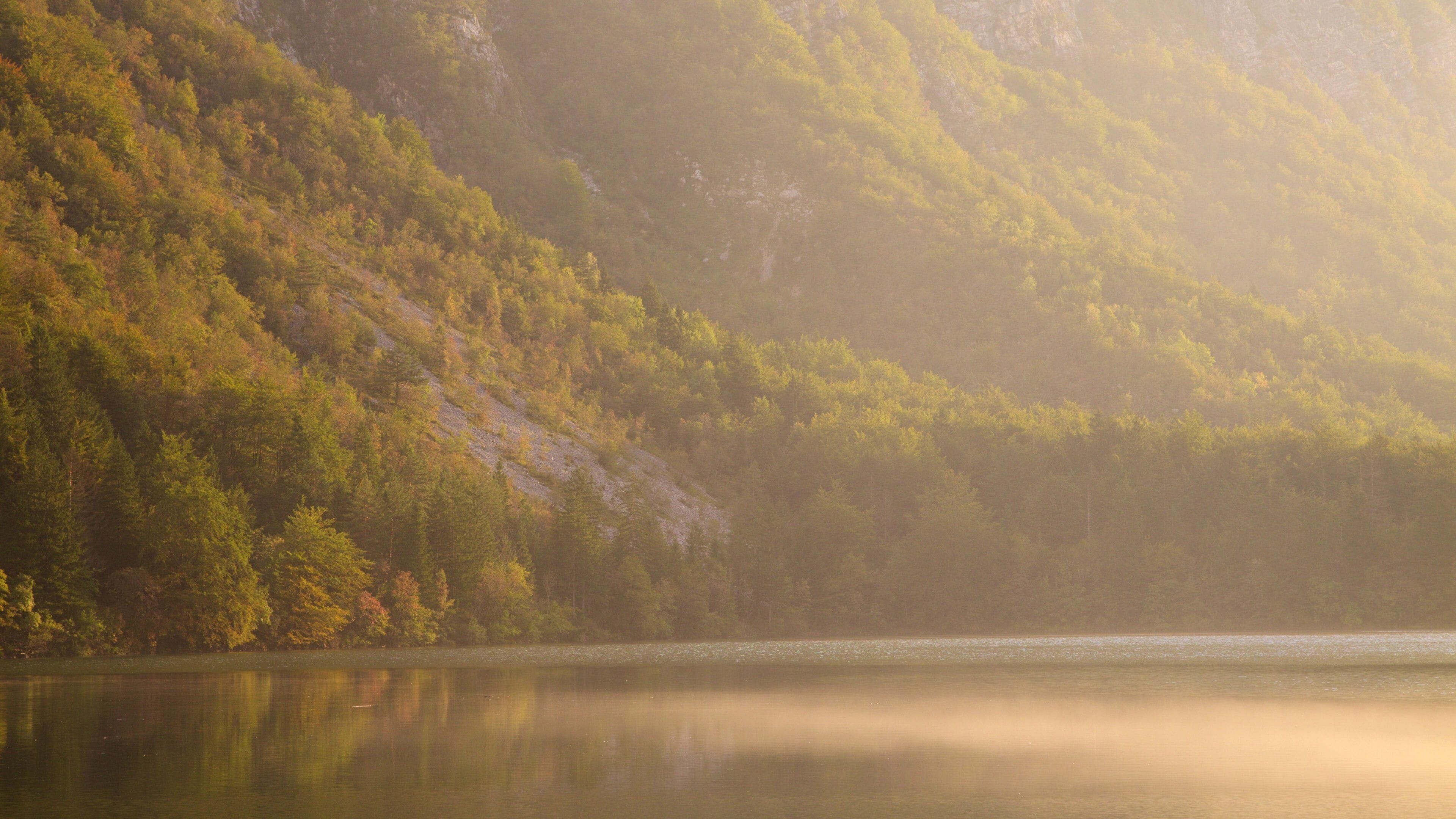 Lake Bohinj which includes a lake or waterhole, mountains and a sunset