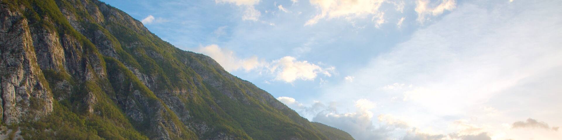 Lake Bohinj showing a lake or waterhole, a sunset and mountains
