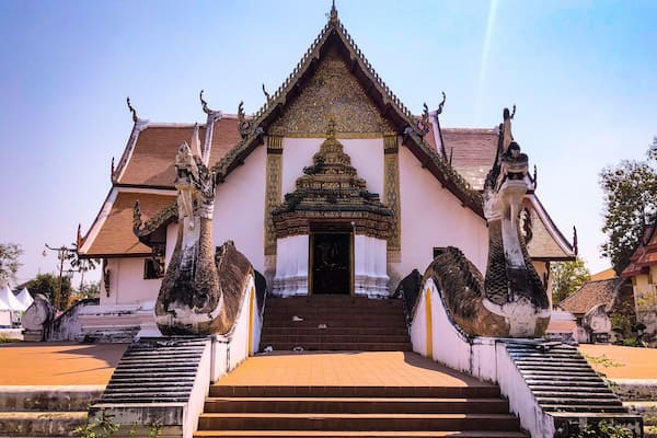 A temple with a multi-tiered roof, a central shrine, and a staircase leading up to the entrance.