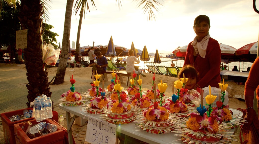 Pattaya Beach showing a sunset and shopping as well as a small group of people
