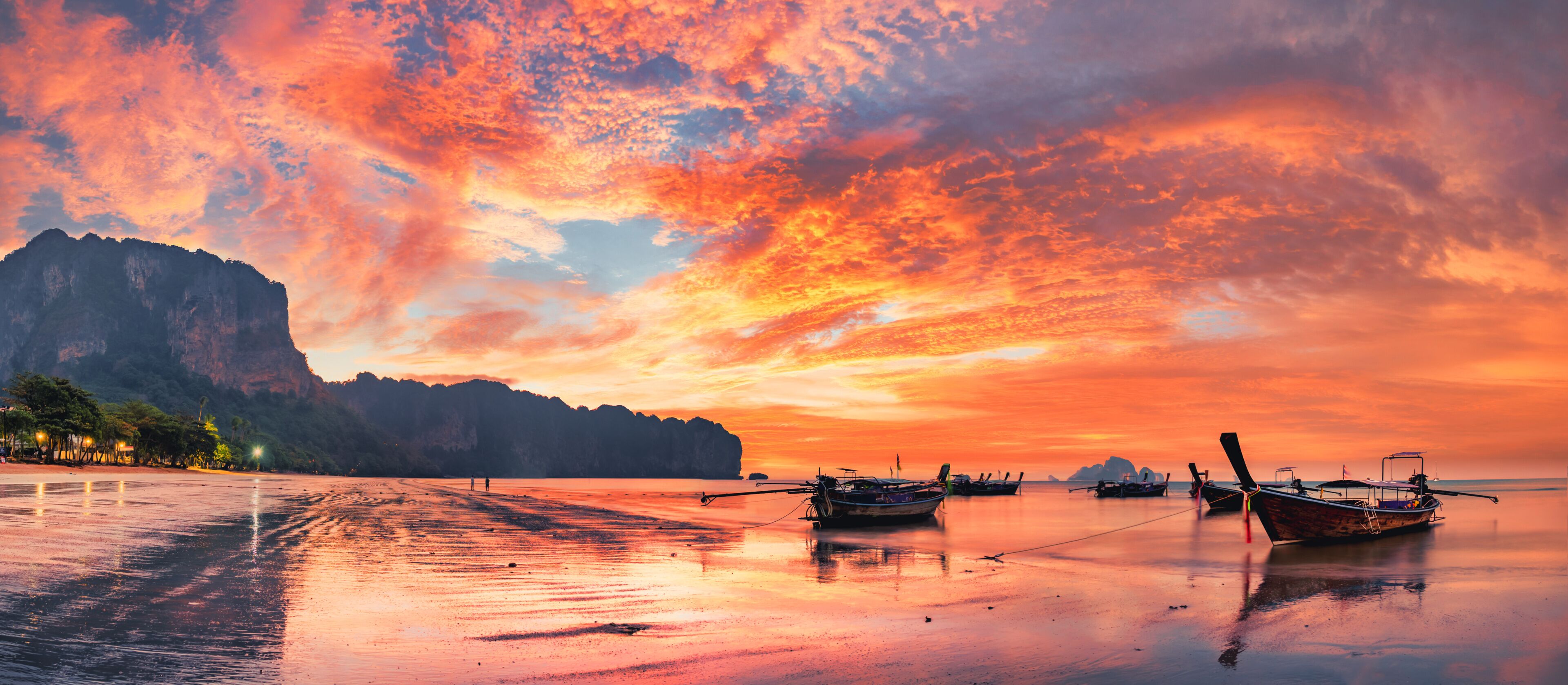 Traditional thai boats at sunset beach. Ao Nang Krabi province
