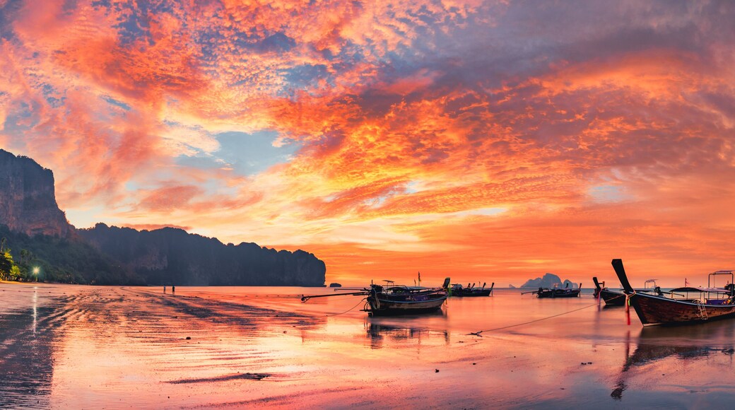 Traditional thai boats at sunset beach. Ao Nang Krabi province