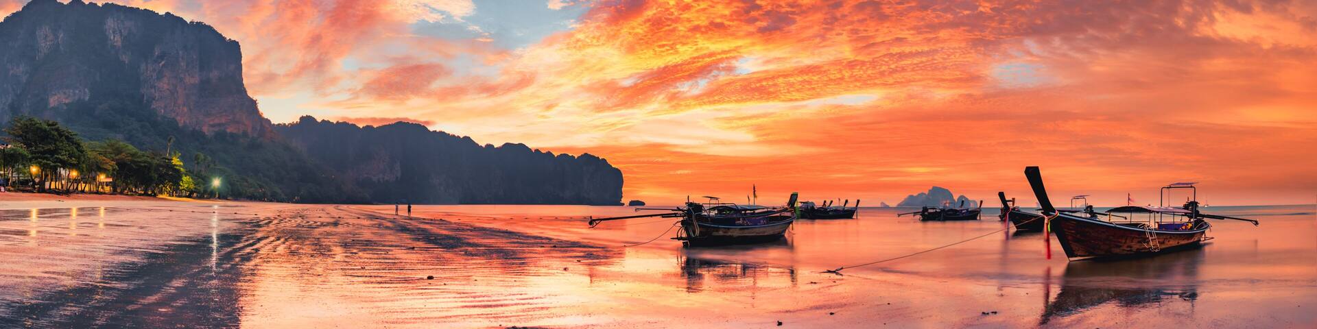 Traditional thai boats at sunset beach. Ao Nang Krabi province