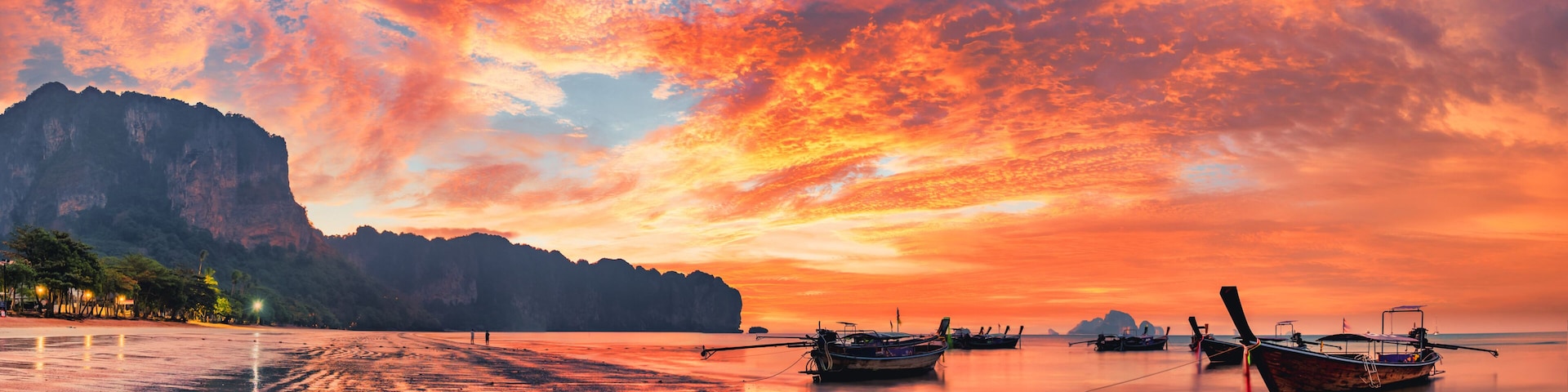 Traditional thai boats at sunset beach. Ao Nang Krabi province