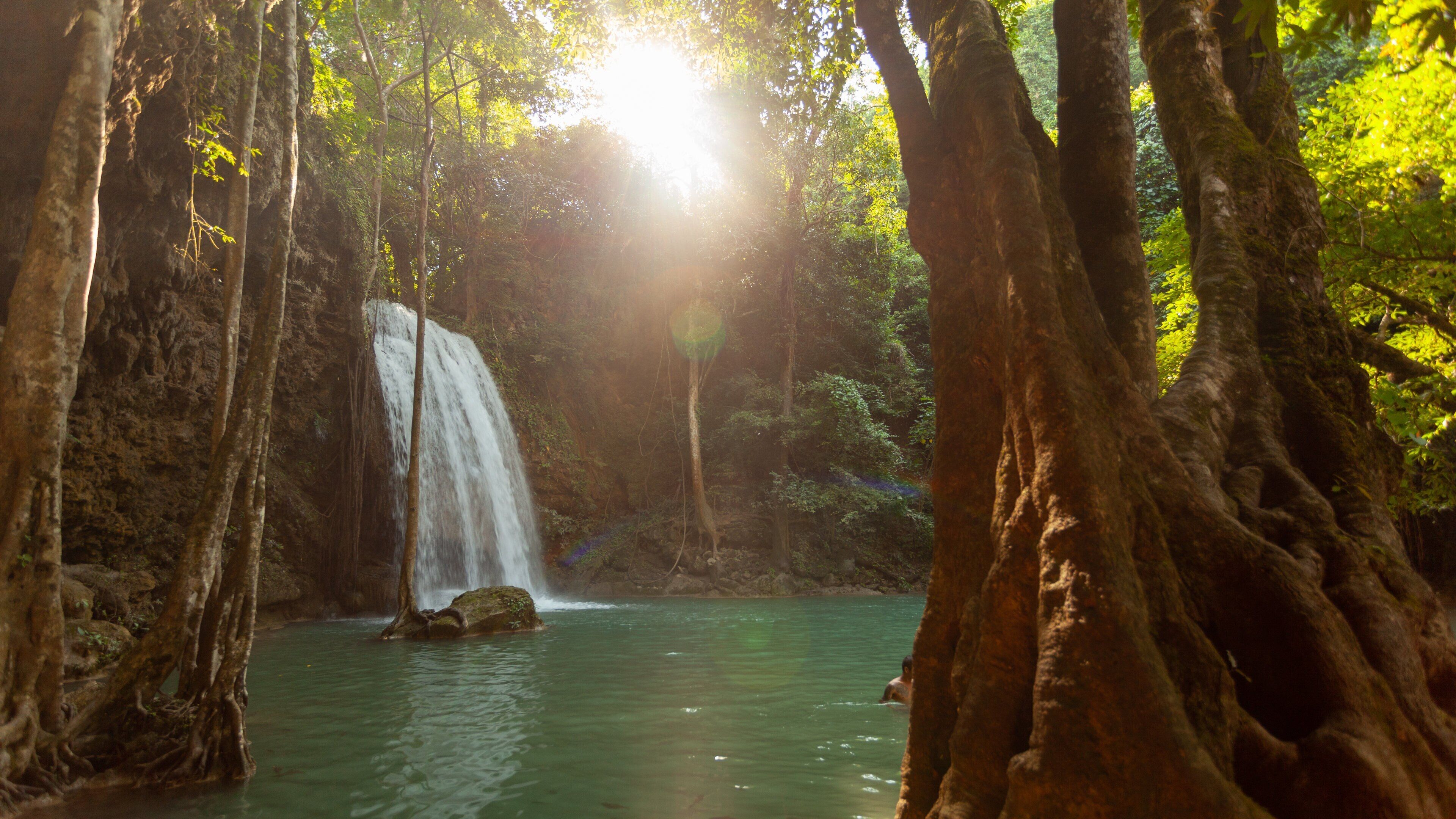 Erawan National Park featuring a lake or waterhole, a cascade and a sunset
