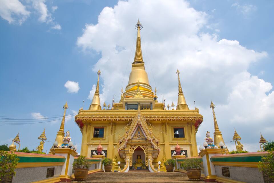 A golden temple with multiple spires and statues.