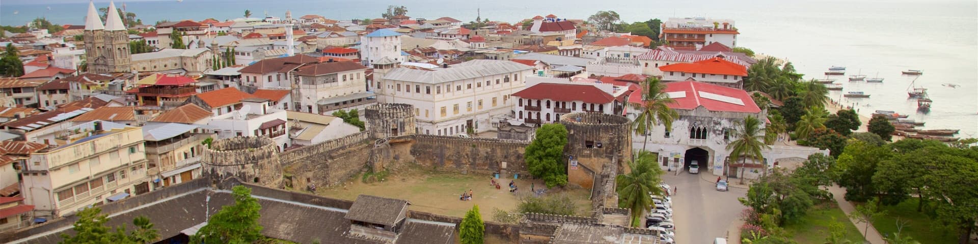 A coastal town with historic buildings, a large open square, and a theater.
