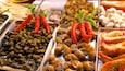 A variety of seafood including snails, shrimp, and mussels.