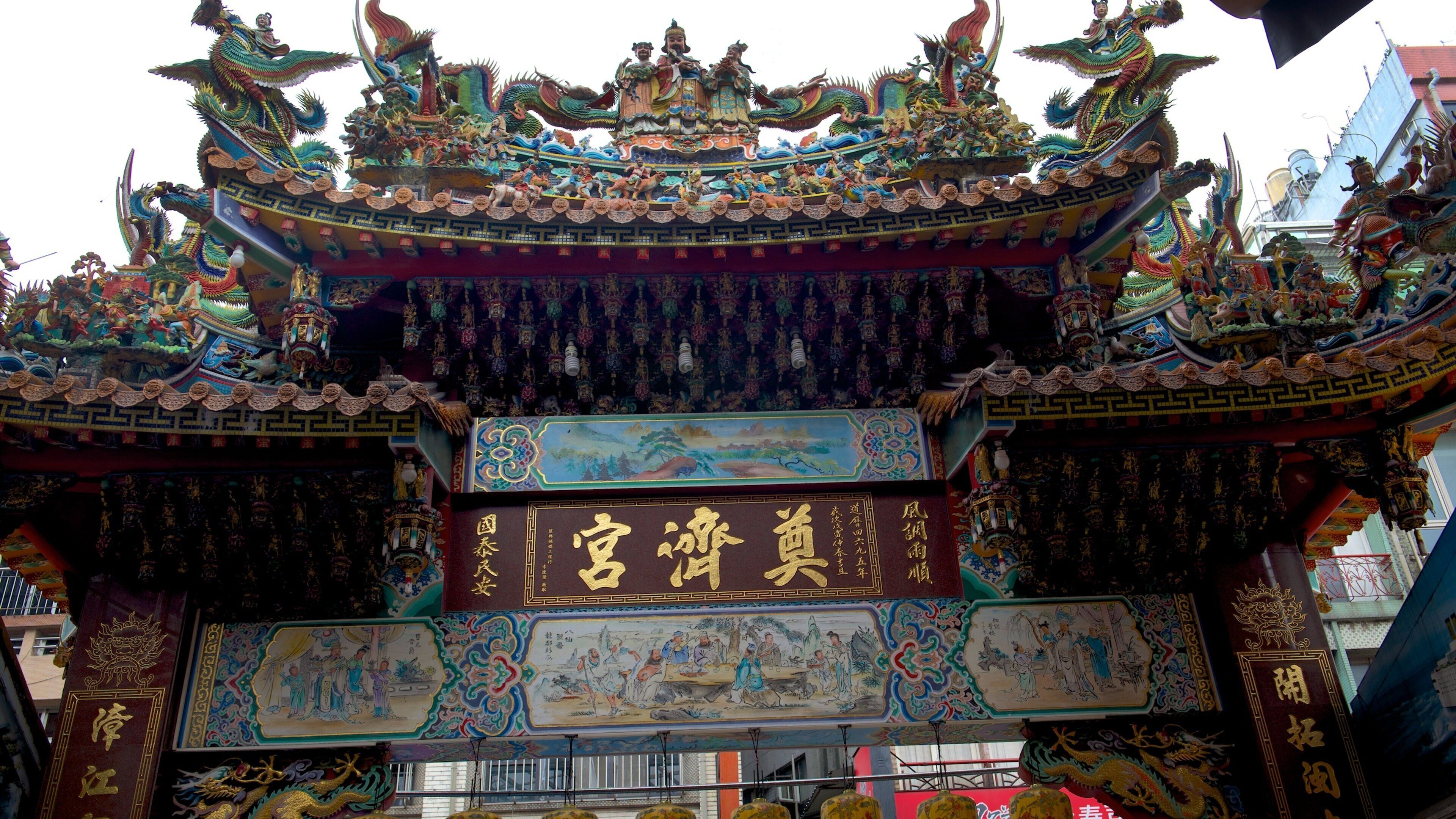 A traditional Chinese gate with intricate carvings and vibrant colors.