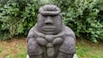 A stone statue with a hat and a scarf.