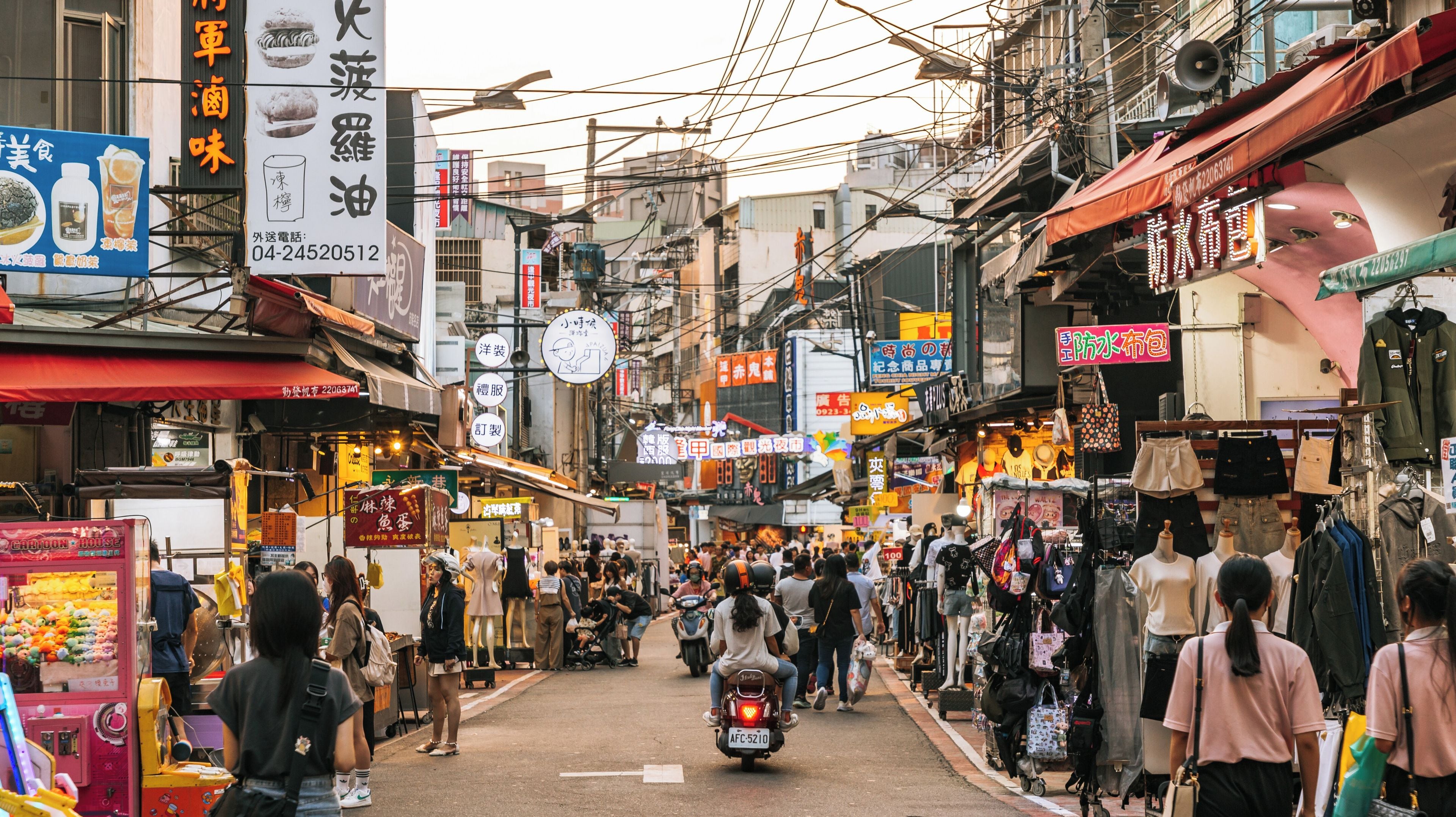 A bustling street market with various shops and stalls.