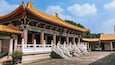 A traditional Chinese building with ornate yellow roofs and green decorations.