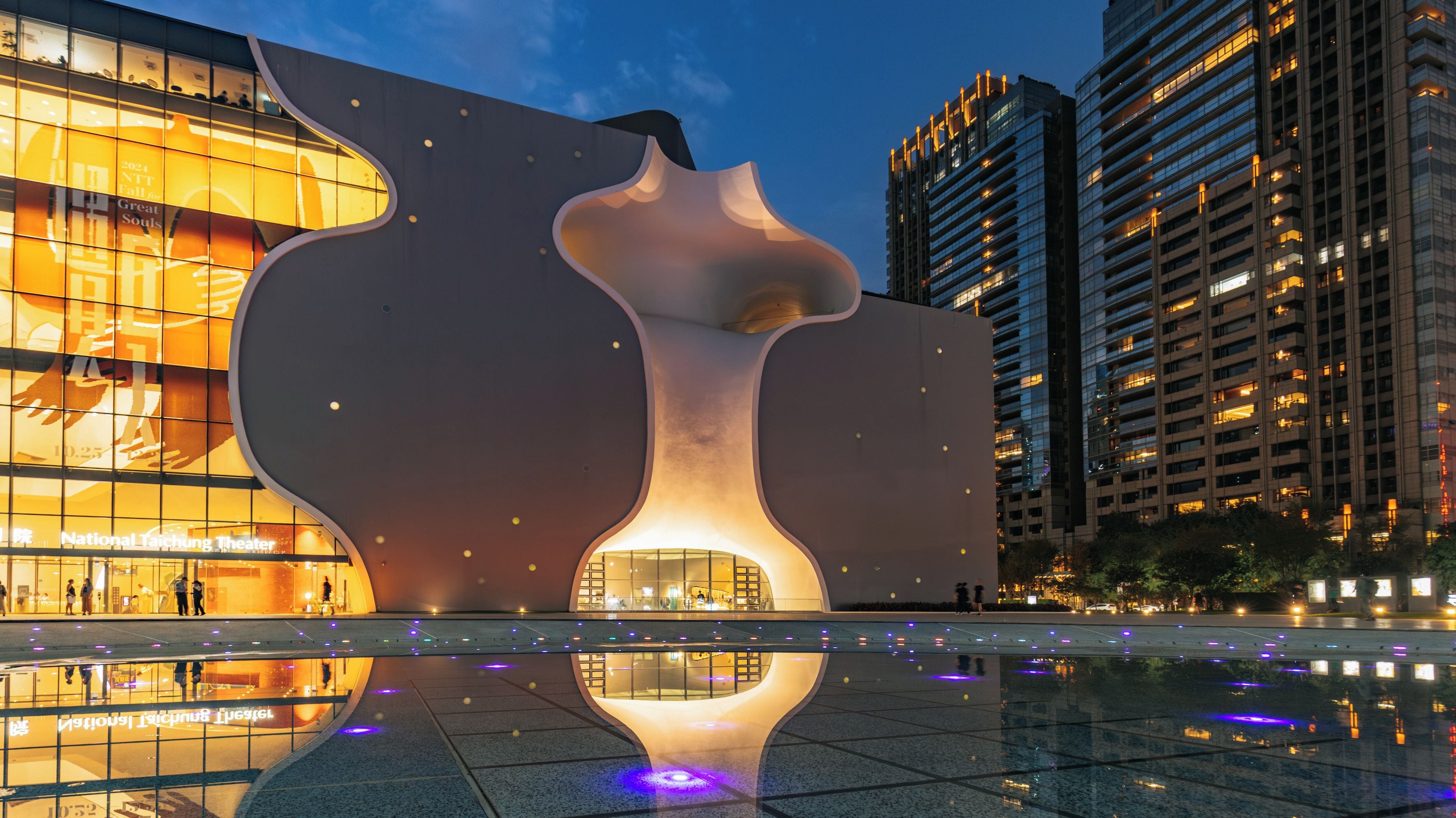 A modern building with a unique architectural design, featuring a large, abstract sculpture-like structure.