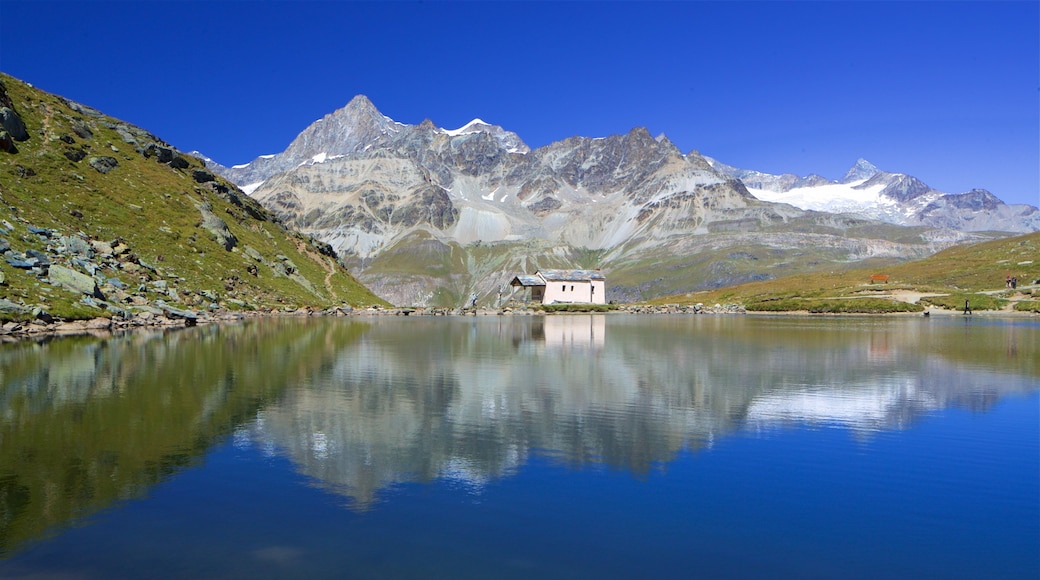 Schwarzsee Lake showing a lake or waterhole and mountains