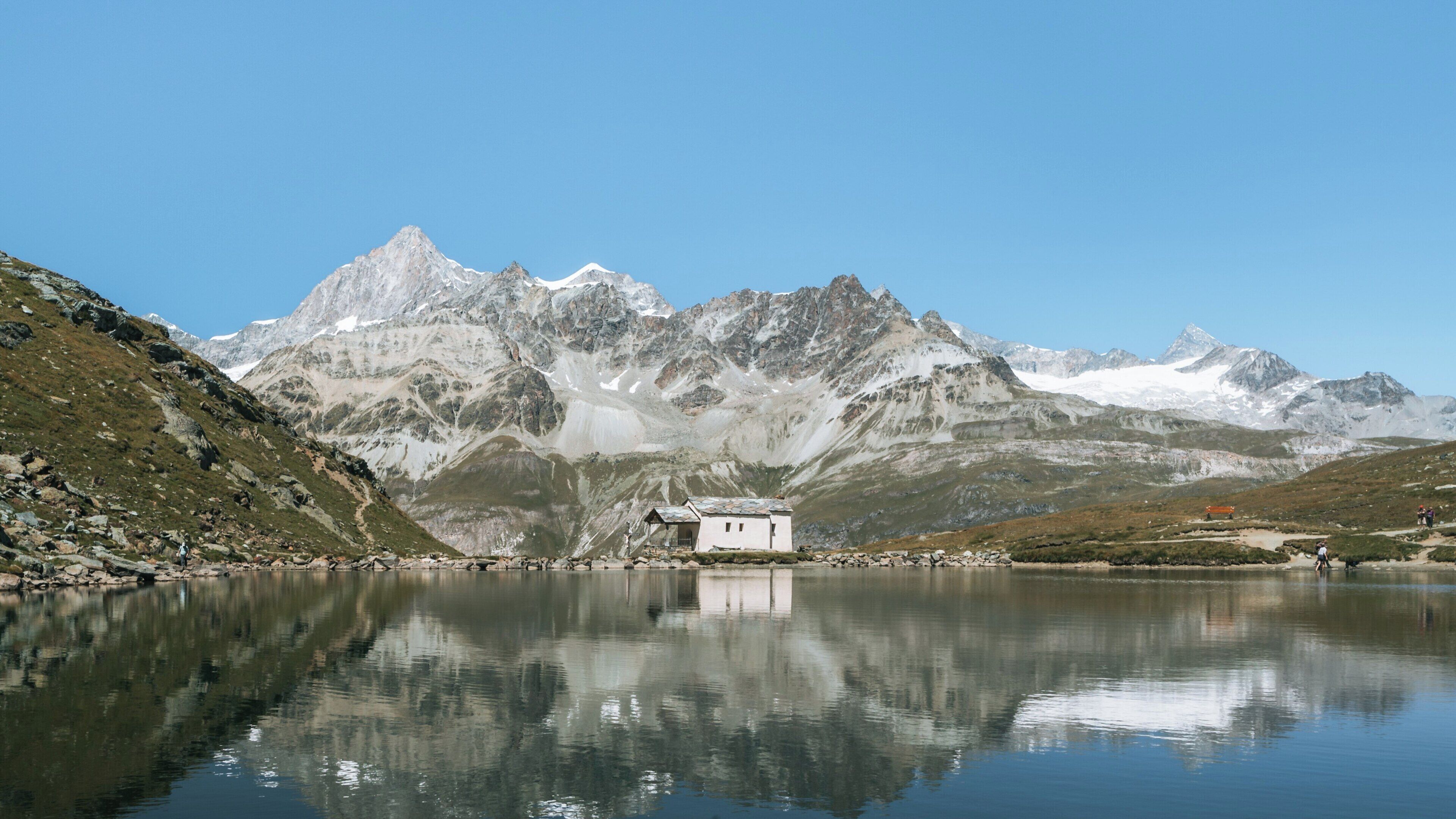Stunning view of Schwarzsee Lake in Zermatt, Valais, Switzerland, reflecting majestic mountains under a clear blue sky