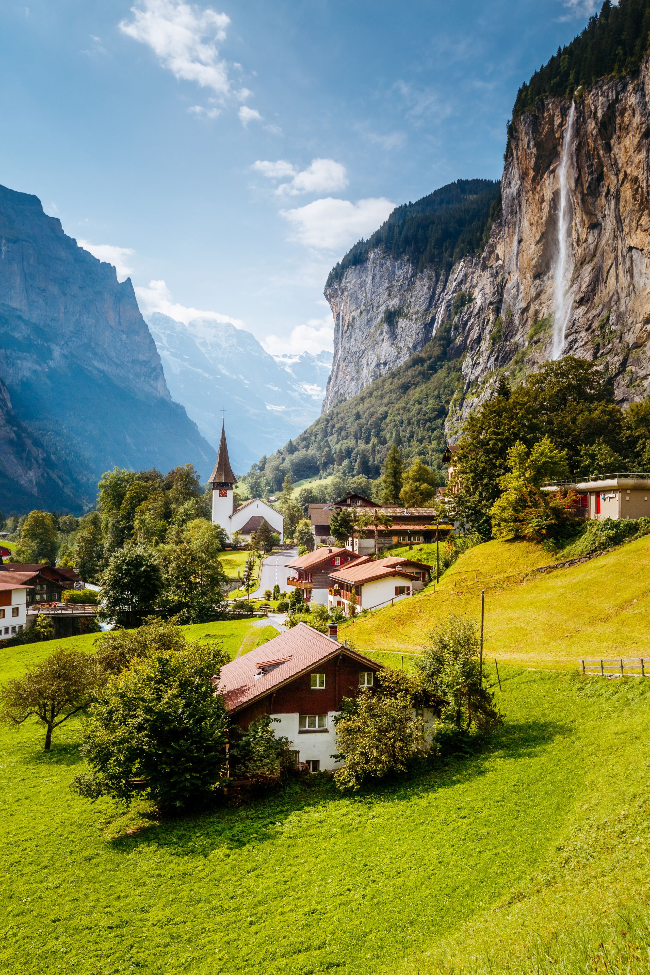 Great view of alpine village glowing by sunlight. Location Swiss alps, Lauterbrunnen valley, Staubbach waterfall, Europe.