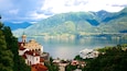 Madonna del Sasso which includes a lake or waterhole and a small town or village