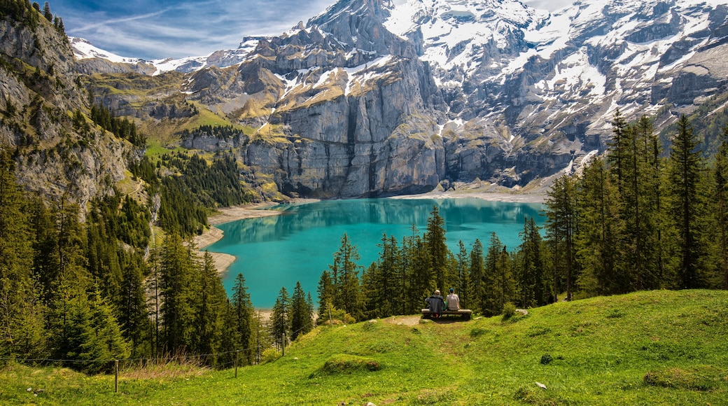 Amazing tourquise Oeschinnensee with waterfalls, wooden chalet and Swiss Alps, Berner Oberland, Switzerland.