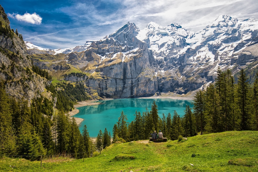 Amazing tourquise Oeschinnensee with waterfalls, wooden chalet and Swiss Alps, Berner Oberland, Switzerland.