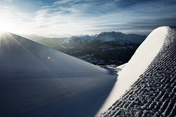 Laax Ski Resort which includes snow, a sunset and landscape views