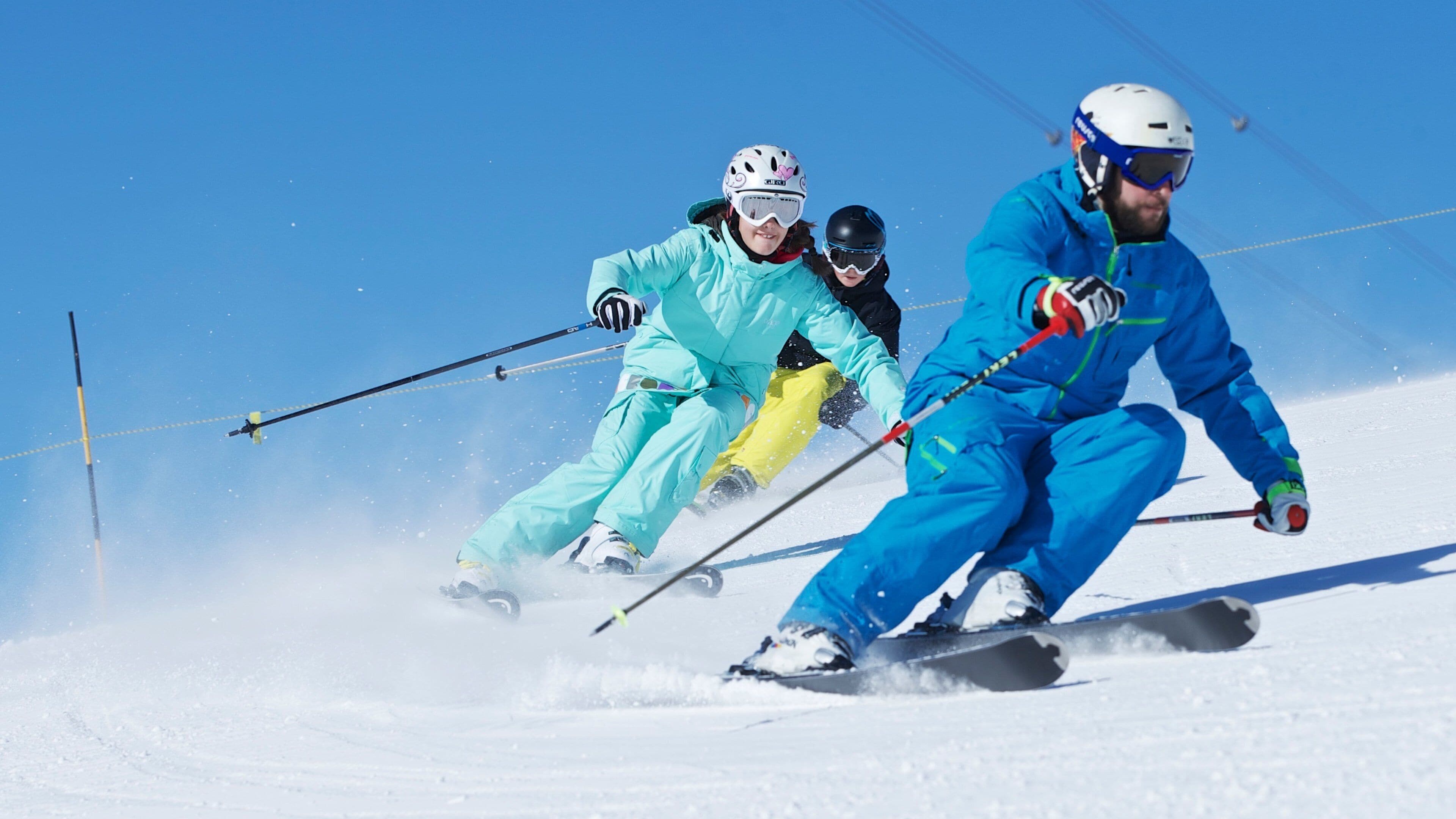 Laax Ski Resort showing snow and snow skiing as well as a small group of people