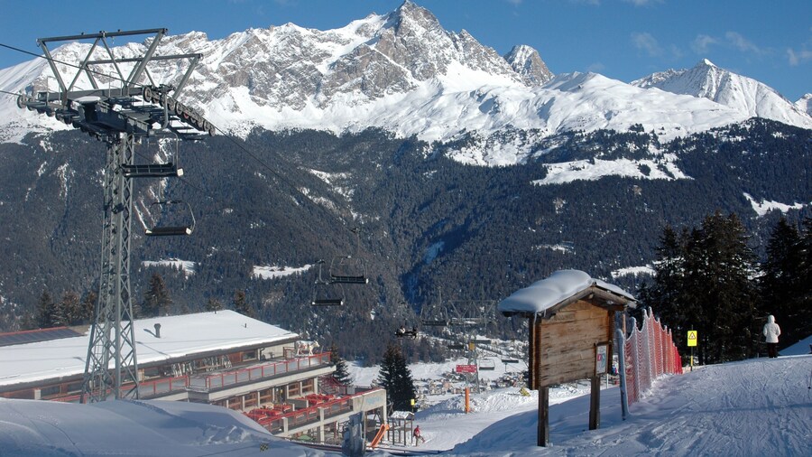 chair lift in a swiss ski resort called savognin with the alps on the horizon