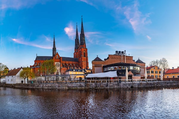 Sunset view of Uppsala cathedral reflecting on river Fyris in Sweden