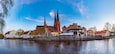 Sunset view of Uppsala cathedral reflecting on river Fyris in Sweden