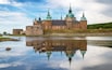 Kalmar Castle on a quiet summer morning with reflection in the calm water in the foreground.