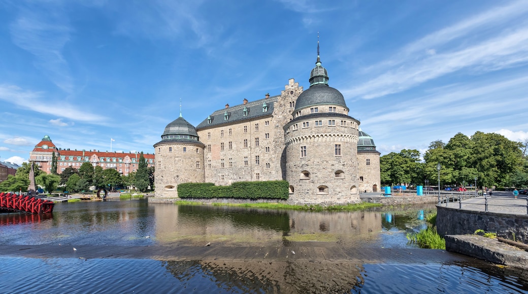 Orebro castle reflecting in water on sunny summer day in city Orebro, Sweden