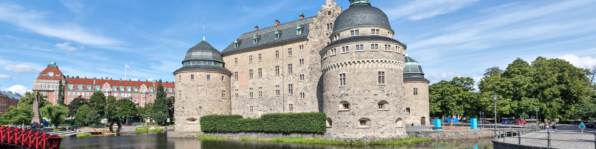 Orebro castle reflecting in water on sunny summer day in city Orebro, Sweden