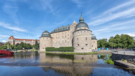 Orebro castle reflecting in water on sunny summer day in city Orebro, Sweden