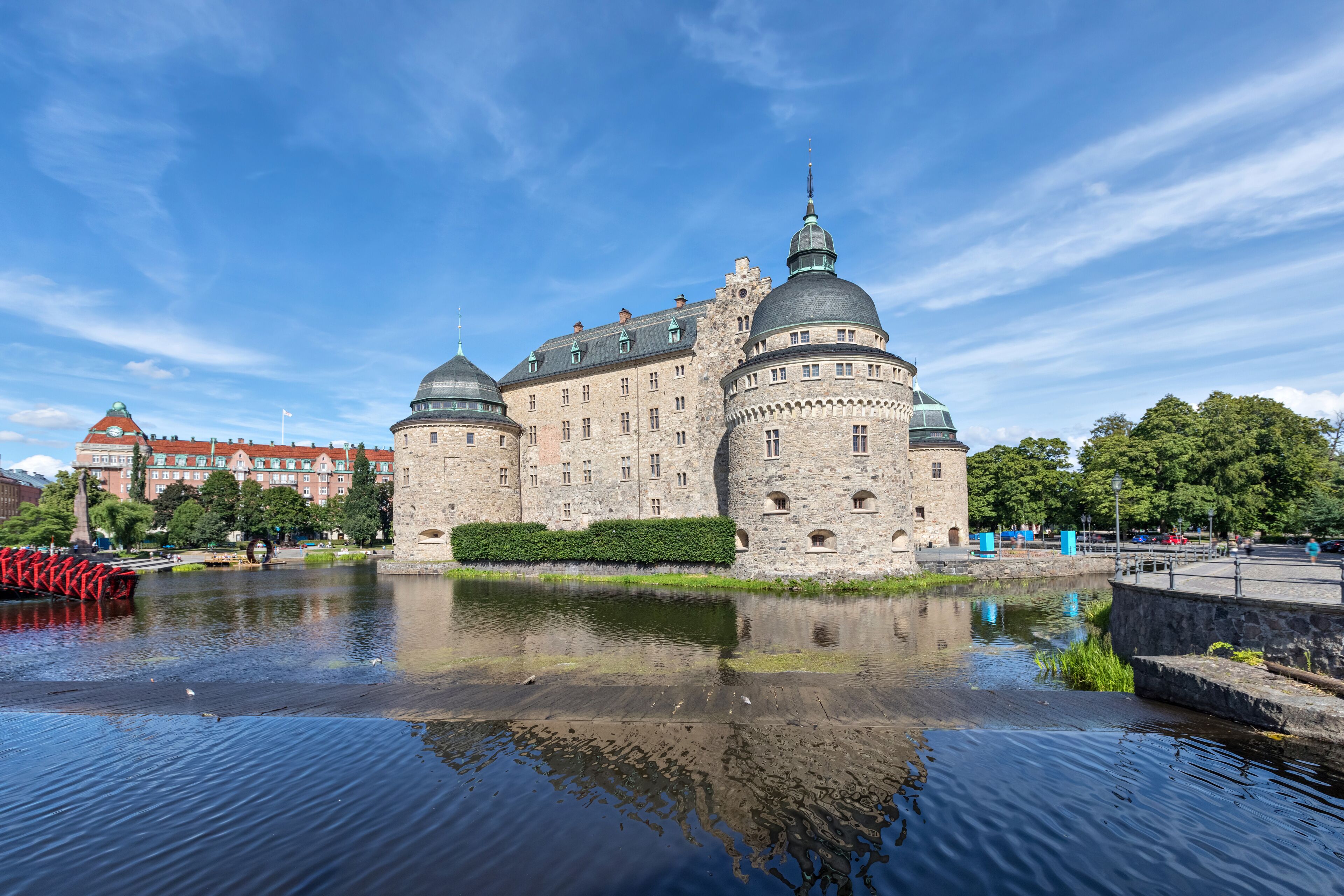 A historic castle with multiple domes and a moat.