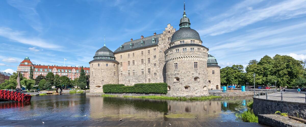 A historic castle with multiple domes and a moat.