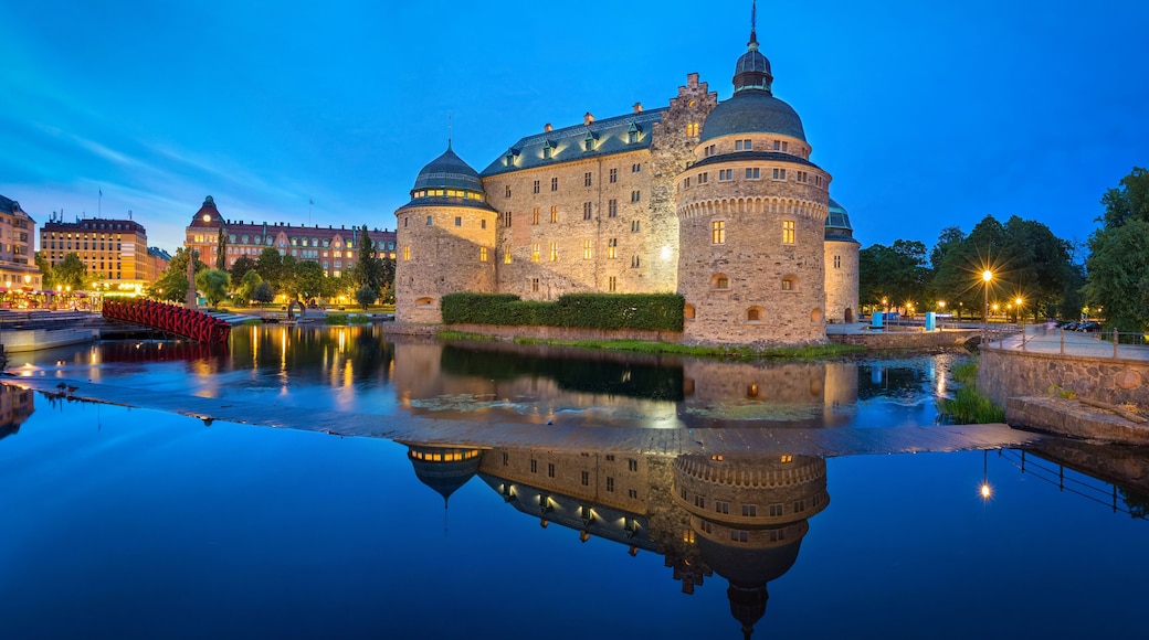 Medieval Orebro Castle reflecting in water in the evening in Orebro, Sweden